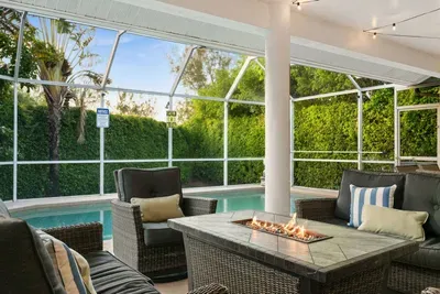 Outdoor Lounge: Relax by the pool with friends around a fire feature and lush greenery!