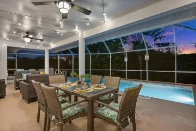 Outdoor Oasis: Dine al fresco under twinkling lights by the sparkling pool—pure vacation bliss!