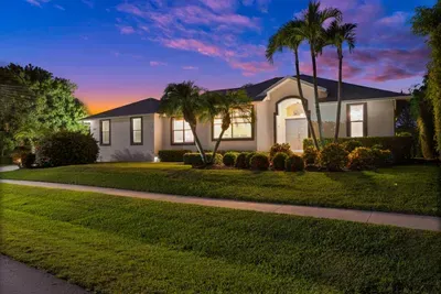 Charming Exterior: Stroll through lush greenery to this inviting Marco Island getaway!