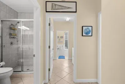 Hallway Bathroom: Spa-like shower and beachy decor invite rejuvenation after sun-soaked adventures!