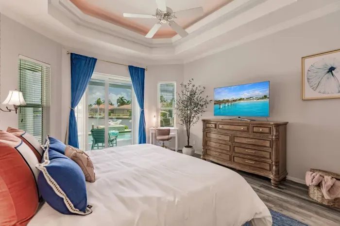 Bedroom Retreat: Enjoy serene waterside views from this elegantly styled retreat with a TV!