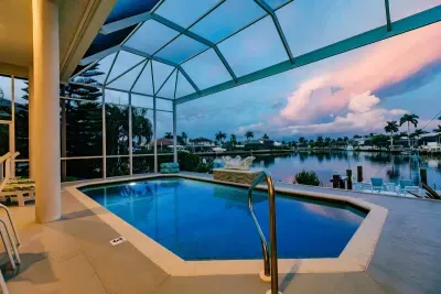Poolside Paradise: Dive into luxury with stunning waterfront views and vibrant sunset hues!