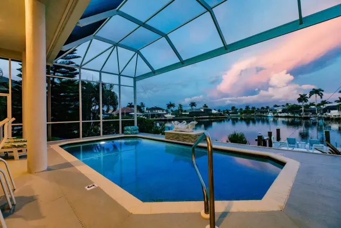Poolside Paradise: Dive into luxury with stunning waterfront views and vibrant sunset hues!