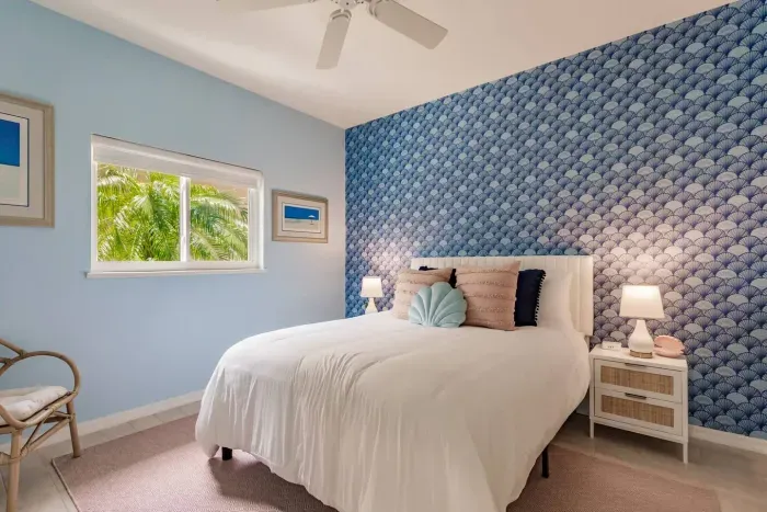 Serene Bedroom Oasis: Relax in a beach-inspired retreat with vibrant decor and natural light!