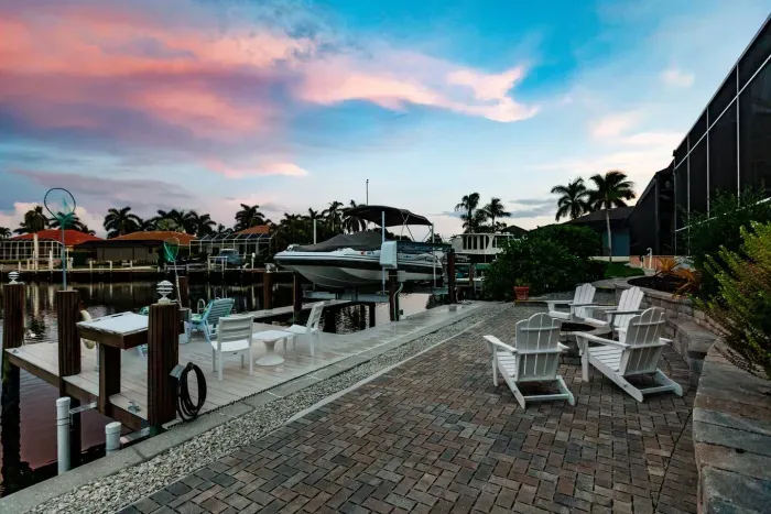Outdoor Oasis: Relax by the water in stylish seating, perfect for sunset views!