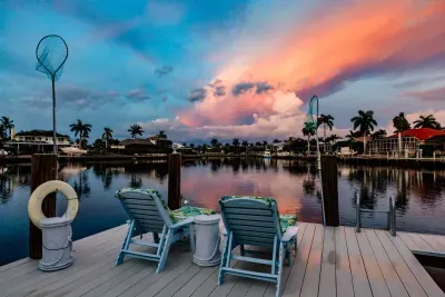 Dockside Serenity: Relax in vibrant chairs while soaking in breathtaking sunset views!