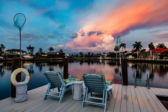 Dockside Serenity: Relax in vibrant chairs while soaking in breathtaking sunset views!