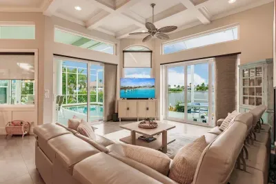 Living Room Oasis: Sun-soaked space with stunning water views and plush seating for ultimate relaxation!