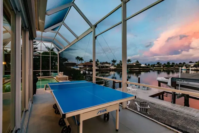 Outdoor Game Area: Play ping pong with stunning waterfront views at sunset! Fun awaits!