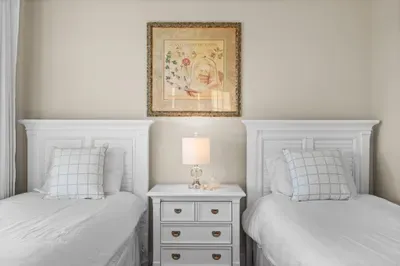 Charming twin bedroom with bright décor and a cozy shared nightstand