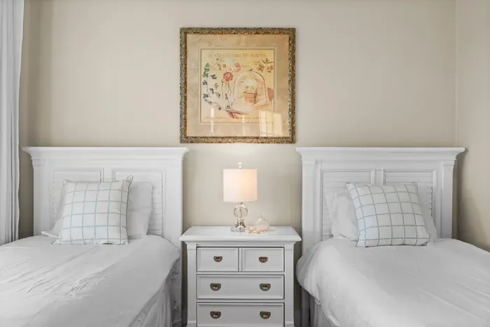 Charming twin bedroom with bright décor and a cozy shared nightstand