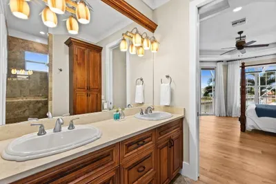 Spacious double-vanity bath with spa shower and bedroom views