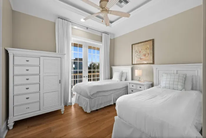 Bright twin bedroom with balcony access and airy coastal style