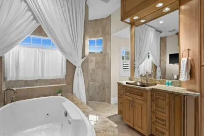 Spa-style bath with jetted tub, walk-in shower, and elegant finishes
