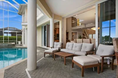 Covered poolside patio with plush seating and seamless indoor-outdoor living