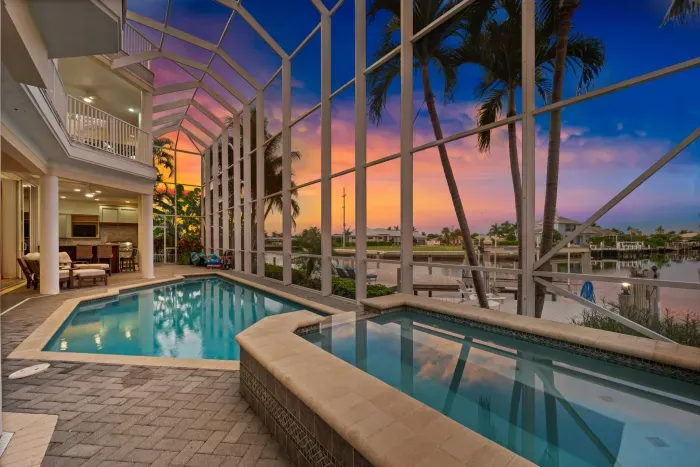 Screened waterfront pool & spa with stunning sunset views
