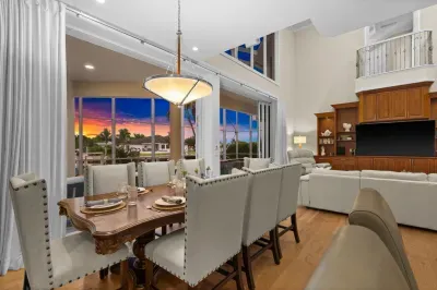 Elegant dining and lounge space with soaring ceilings and sunset views