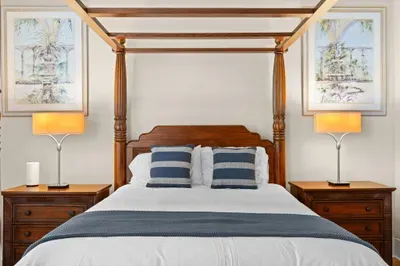Elegant four-poster bedroom with warm lighting and tropical charm