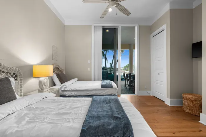 Bright twin bedroom with patio access and tranquil waterfront views