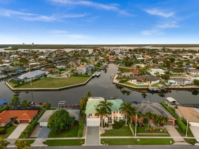 Scenic waterfront neighborhood with canals, docks, and tropical views
