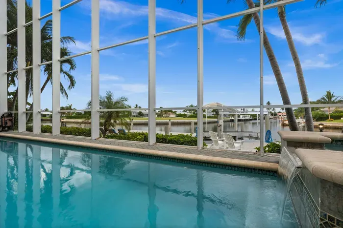Screened waterfront pool with palm views and a relaxing tropical vibe