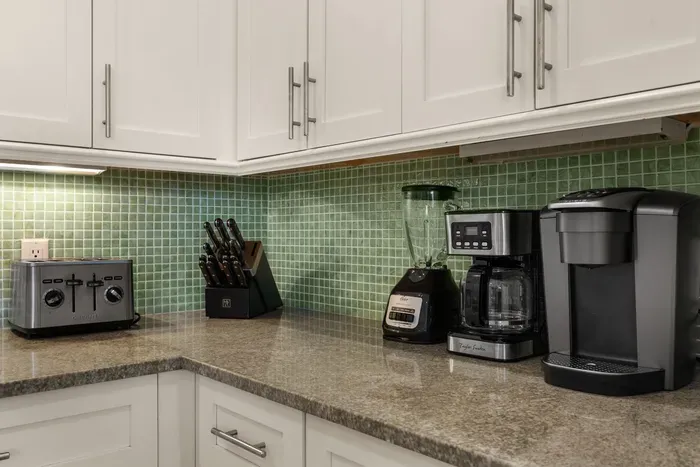 Bright kitchen with granite counters, coffee station, and modern finishes