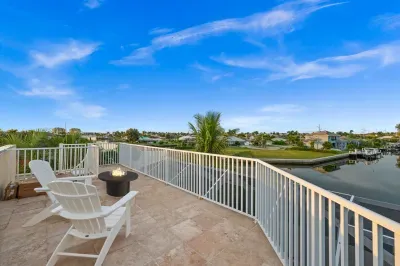 Waterfront terrace with fire table and peaceful canal views