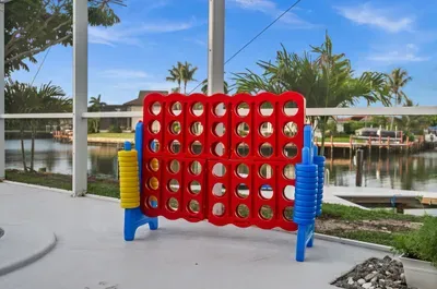 Screened waterfront patio with giant Connect Four and canal views