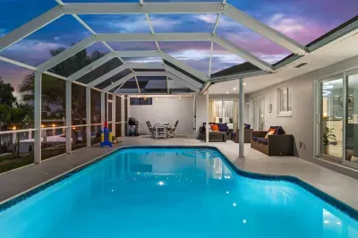 Screened private pool with lounge seating and evening resort-style ambiance