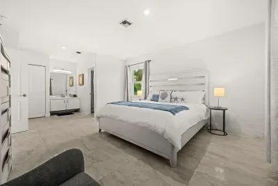 Bright coastal-inspired bedroom with en suite vanity and airy feel
