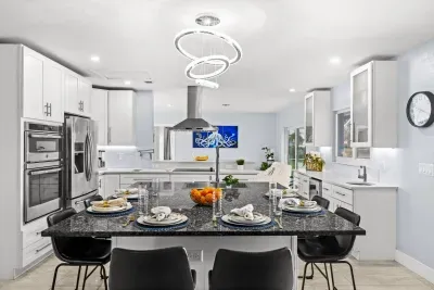 Bright modern kitchen with granite island and stylish dining setup