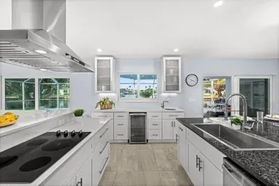 Bright waterfront kitchen with island, modern finishes, and outdoor access