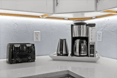 Bright kitchen coffee station with toaster, blender, and coffee maker
