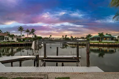 Private waterfront dock with serene canal views and stunning sunset skies