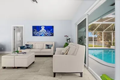 Bright waterfront lounge with pool views and easy indoor-outdoor access