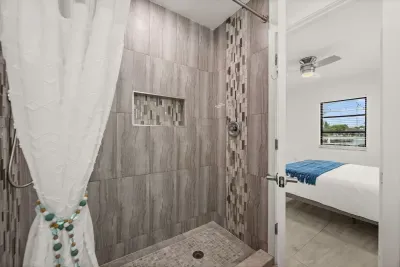 Spa-style walk-in shower with modern tile and easy bedroom access