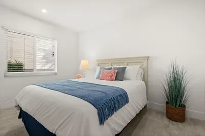 Bright, cozy bedroom with crisp linens and a clean modern feel