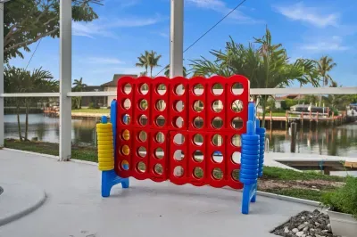Screened waterfront patio with giant Connect Four and canal views