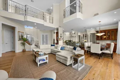 Grand open-concept living with soaring ceilings, chef’s kitchen, and ample seating