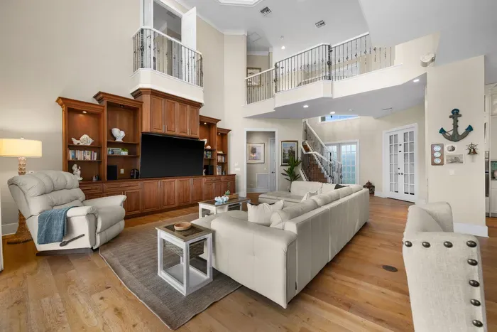 Bright grand living room with high ceilings and elegant built-ins