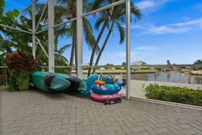 Screened waterfront lanai with palm views and family-friendly outdoor fun