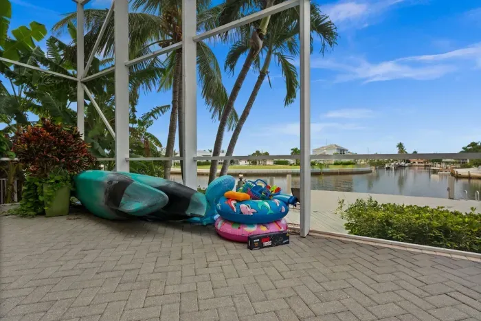 Screened waterfront lanai with palm views and family-friendly outdoor fun