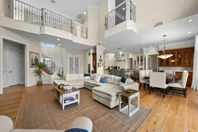 Grand open-concept living with soaring ceilings, chef’s kitchen, and ample seating