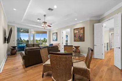 Bright living space with balcony access and scenic water views