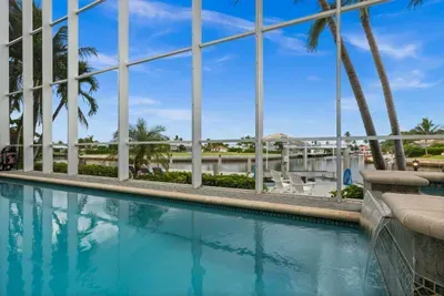 Screened waterfront pool with palm views and a serene resort-style feel