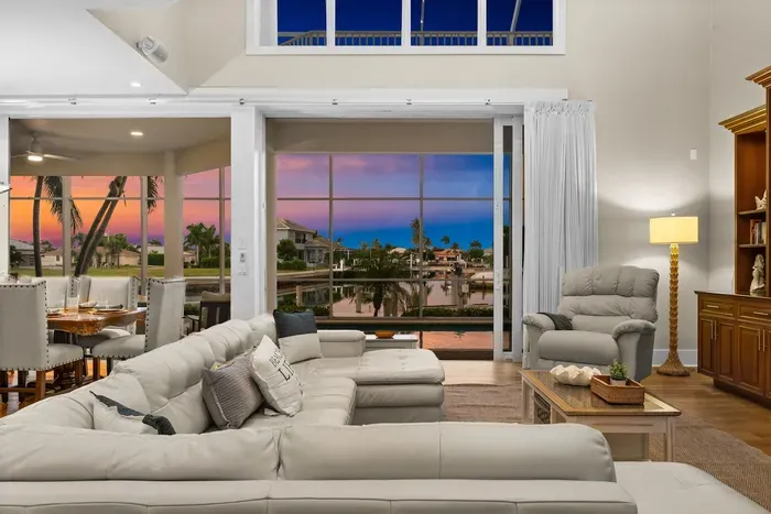 Spacious waterfront living room with sunset views and bright, airy design
