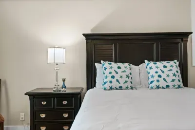 Cozy bedroom with elegant dark wood furnishings and beachy accents