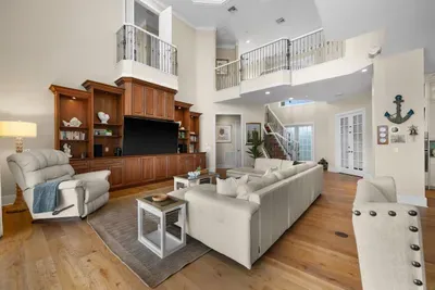 Bright grand living room with high ceilings and elegant built-ins