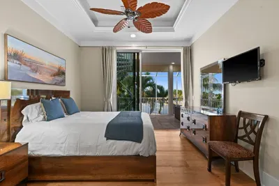 Bright tropical bedroom with private balcony and serene outdoor views