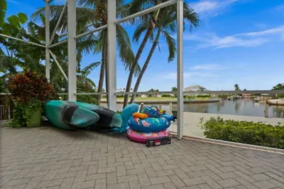 Screened waterfront lanai with palm views and family-friendly outdoor fun